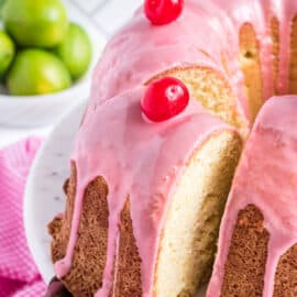 Slice of cherry pound cake being removed from plate.