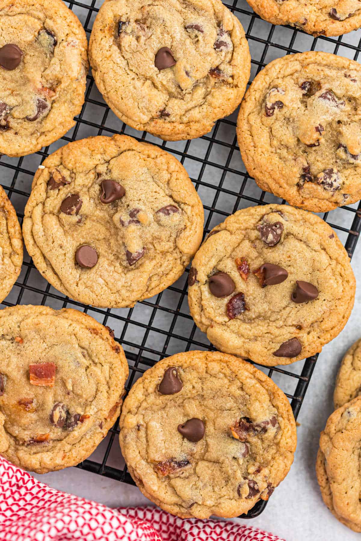 Chocolate chip bacon cookies on a cooling rack.