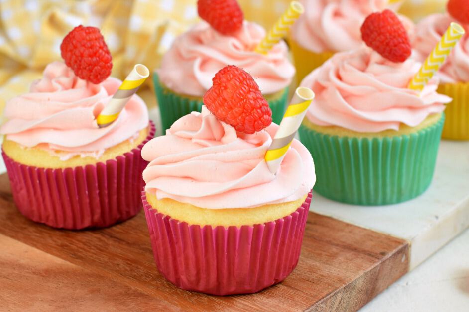 Raspberry Lemonade cupcakes on marble cutting board.