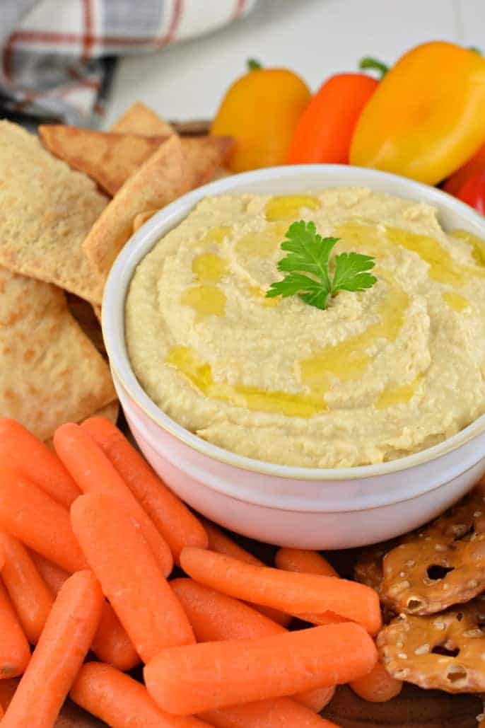 Hummus with vegetables and pita chips.