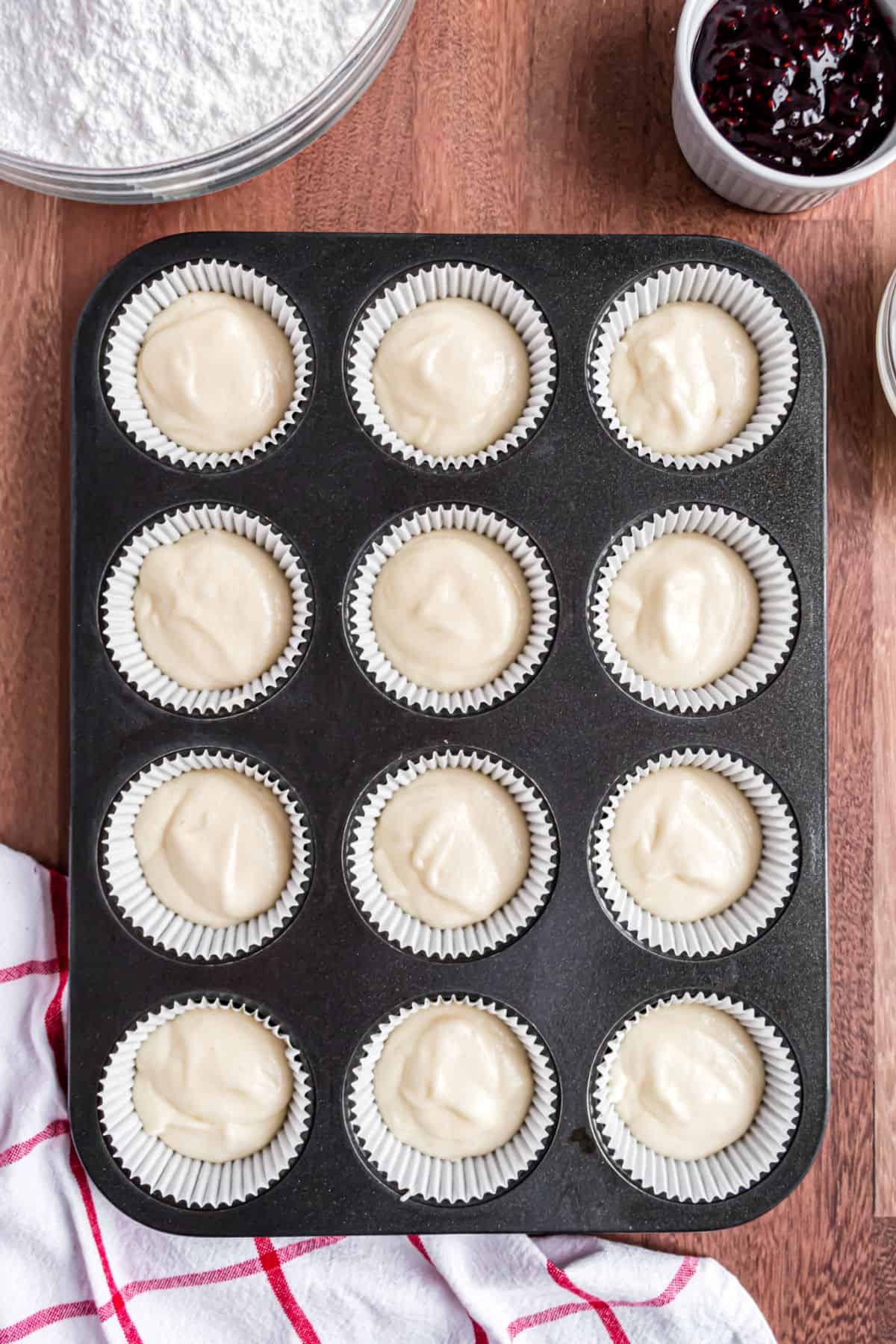 Almond cupcake batter in tin before baking.