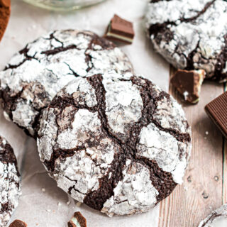 Chocolate mint cookies stacked on parchment paper.