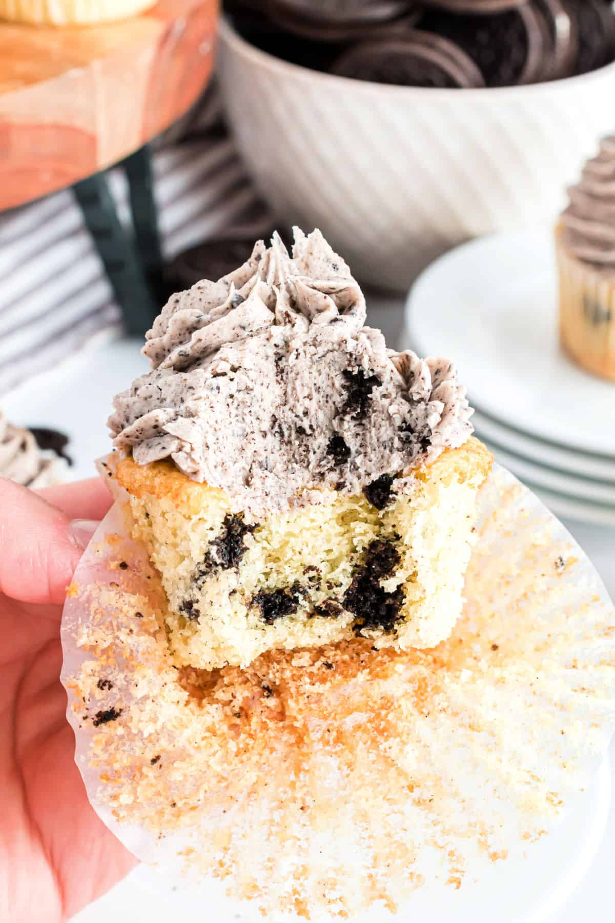 Oreo cupcake with oreo frosting and a bite taken out.