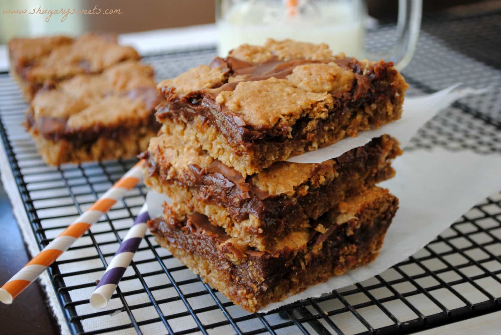 Revel bars cut into squares and stacked on a wire cooling rack.
