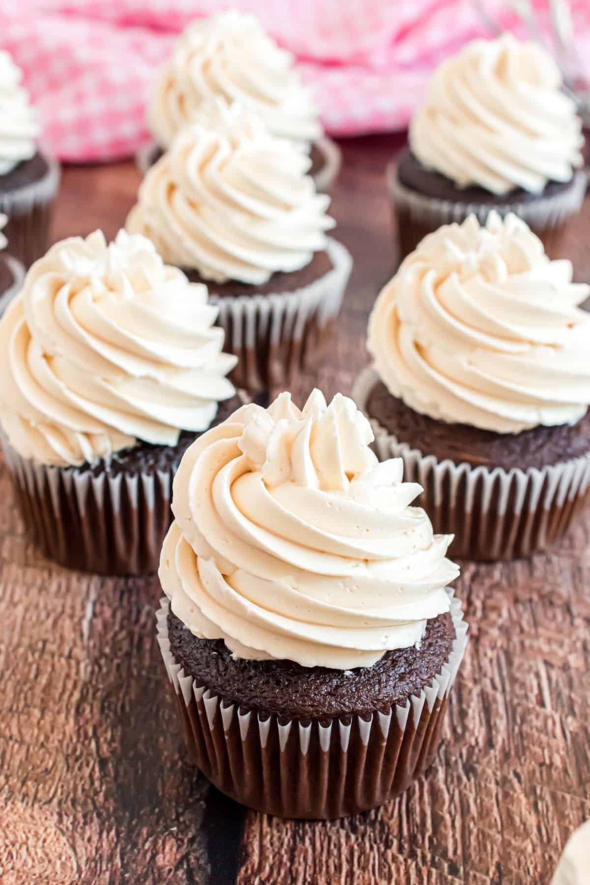 Salted caramel frosting piped high on a chocolate cupcake.
