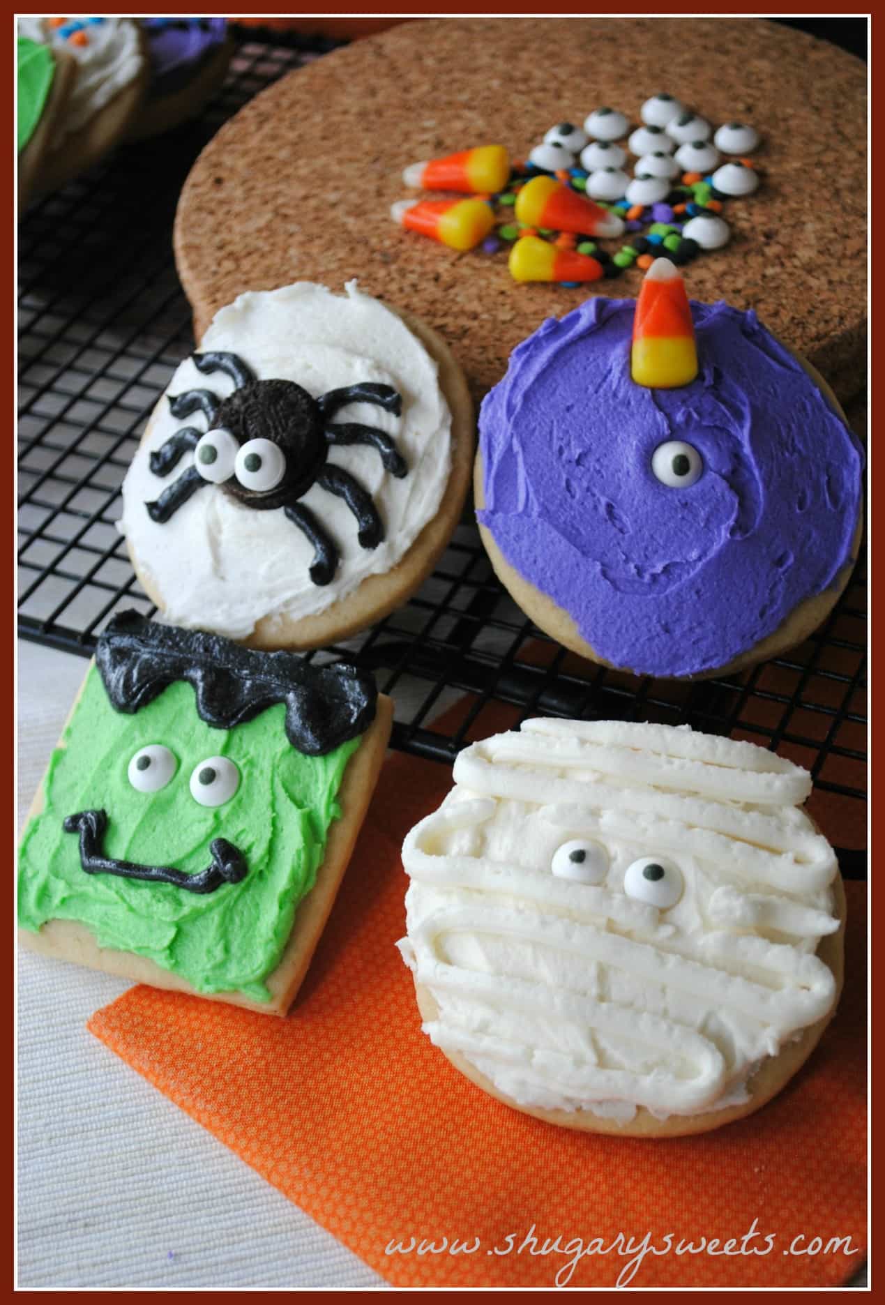 4 sugar cookies decorated like Halloween monsters.