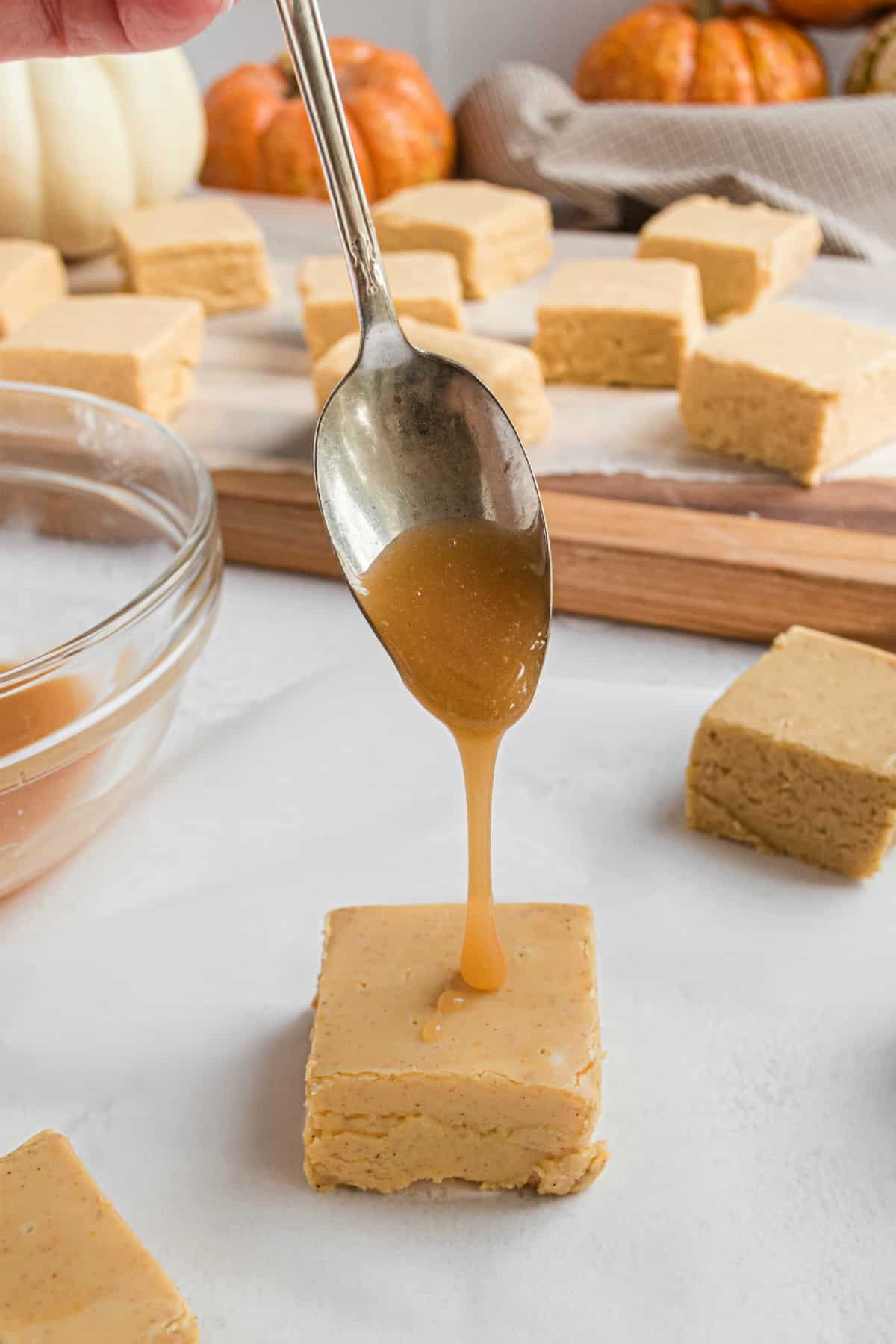 Caramel drizzled from spoon onto fudge.