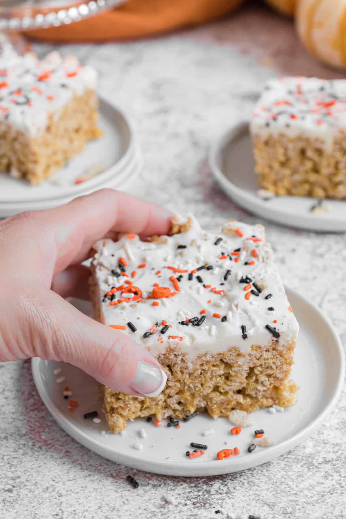 Rice krispie treat being lifted off plate.