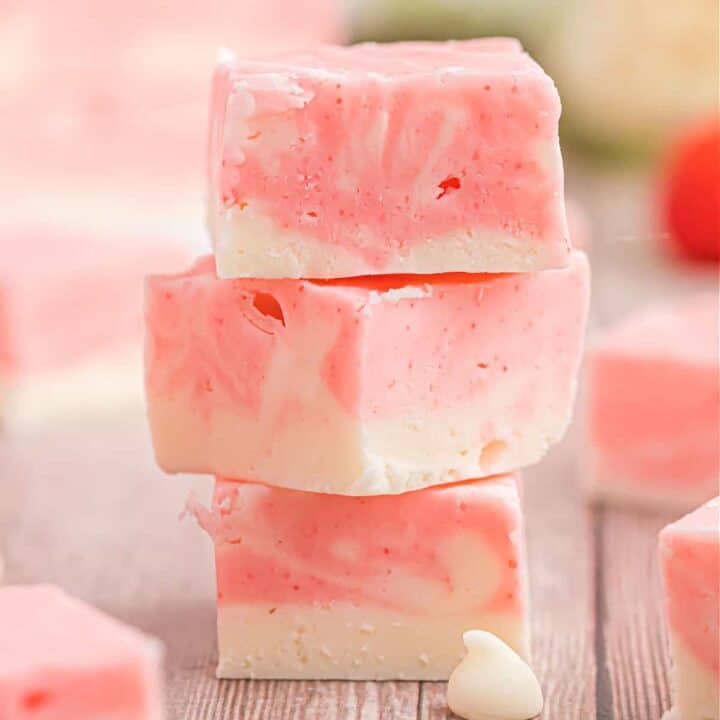 Velvety smooth fudge that's pretty in pink! This Strawberry Swirl Fudge recipe makes it easy to create homemade candy with swirls of vanilla and strawberry fudge with no candy thermometer needed!