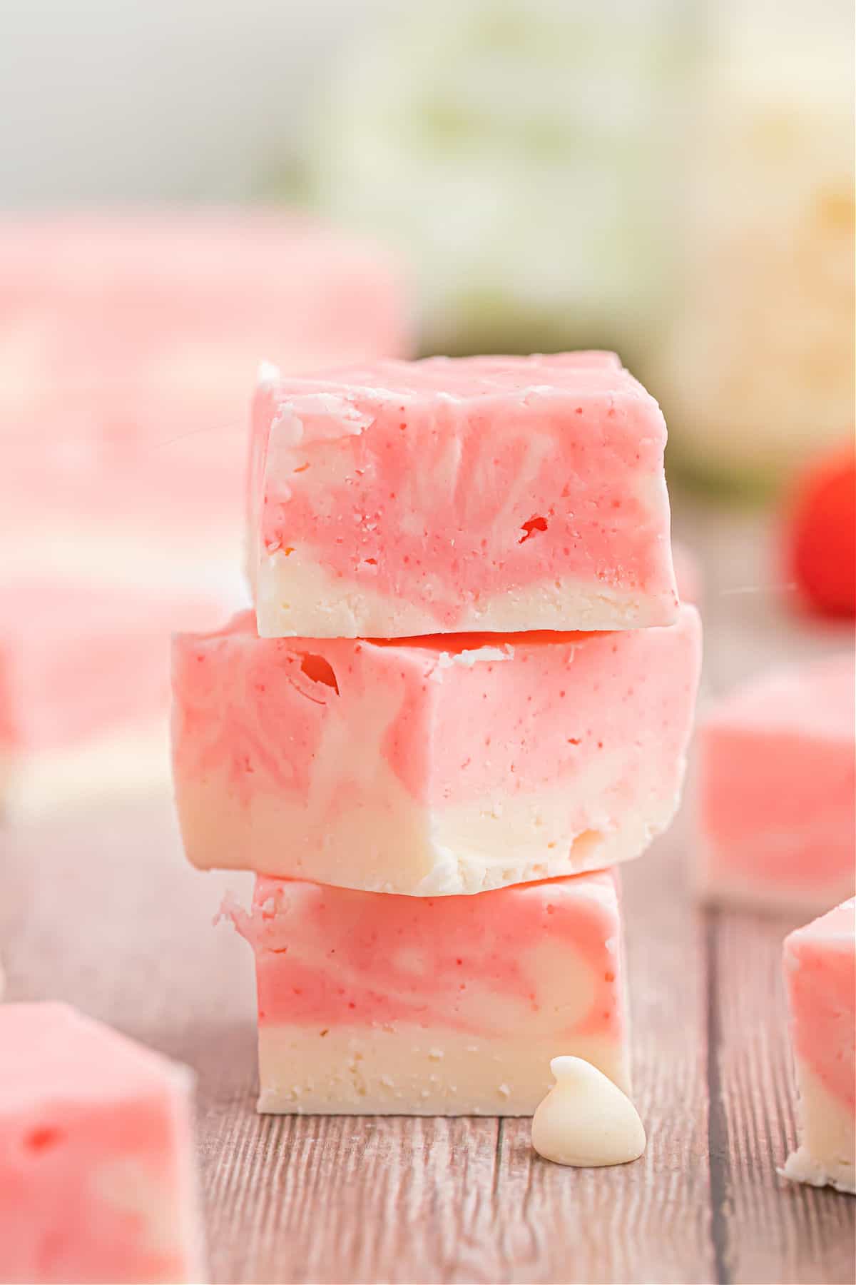 Stack of three strawberry swirl fudge pieces.