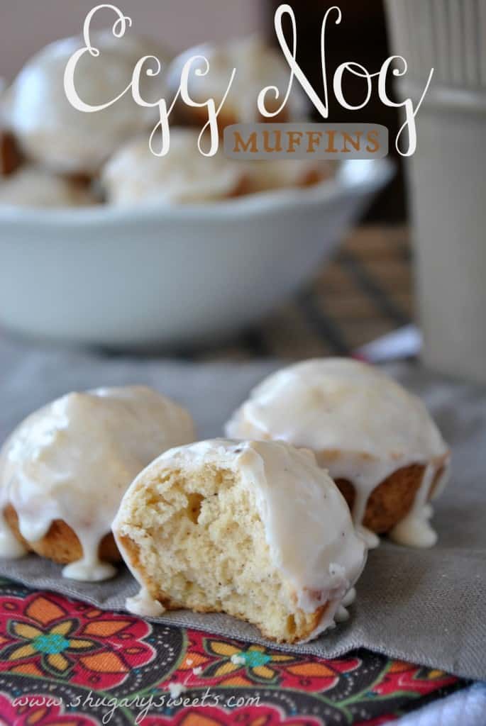 Eggnog mini muffins on a linen with one bite removed.