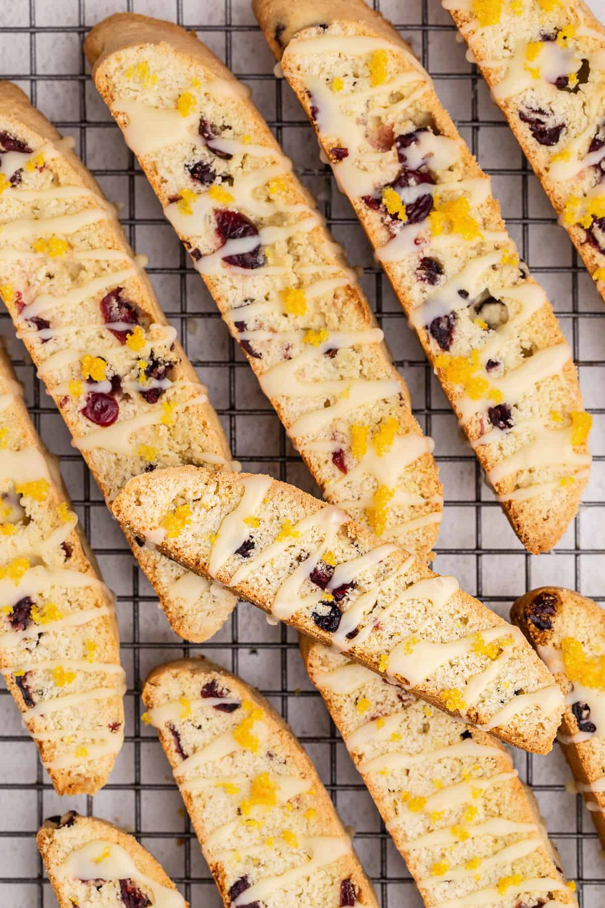 Cranberry orange biscotti on a wire cooling rack.
