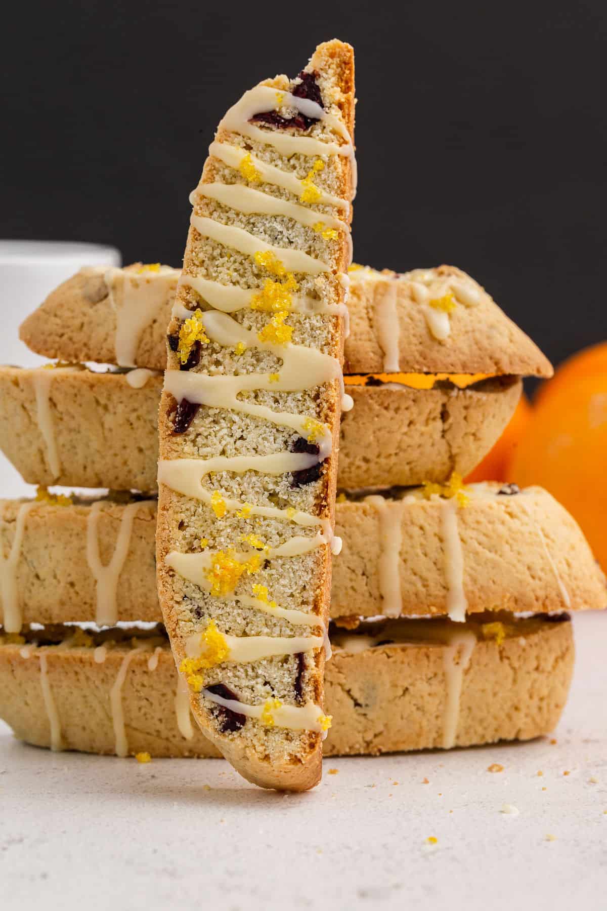 Cranberry orange biscotti stacked with one biscotti vertical.