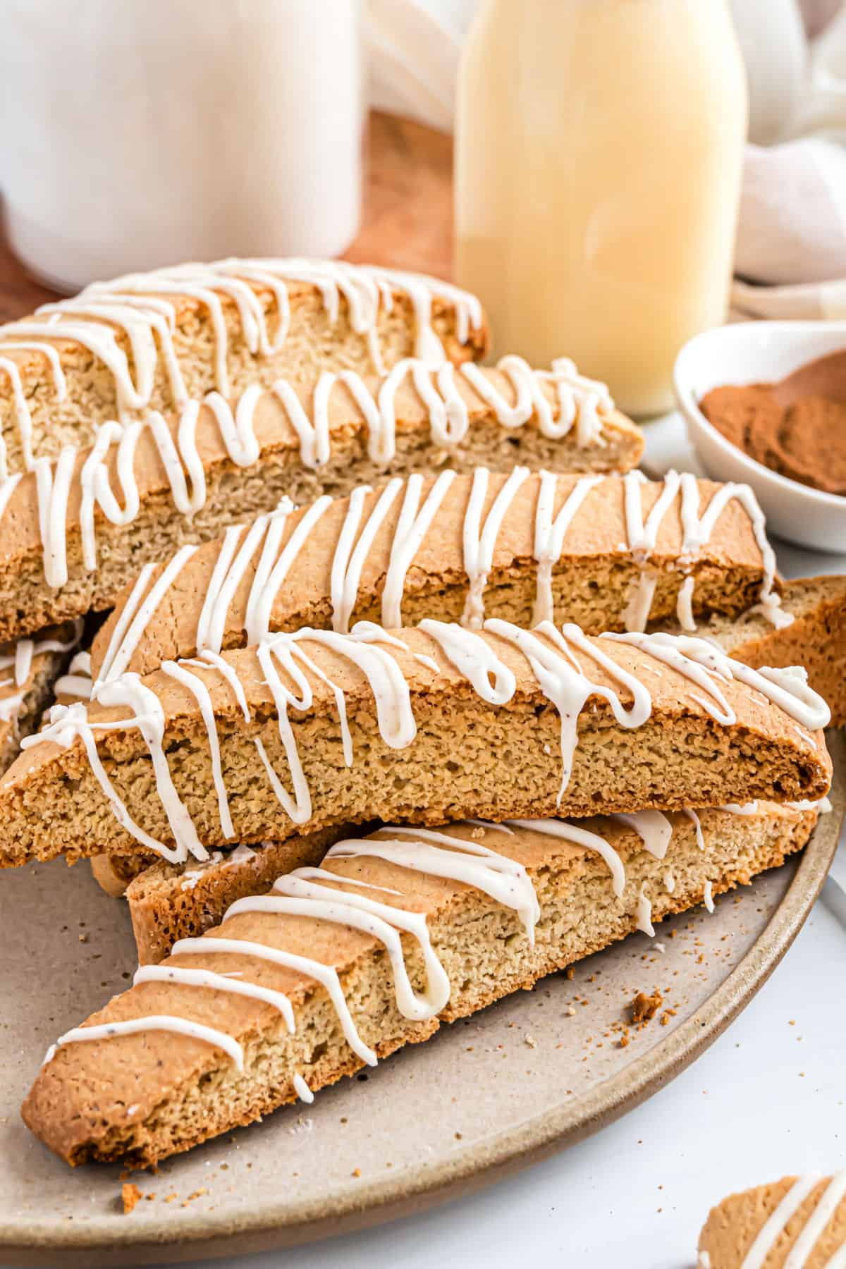Eggnog flavored biscotti stacked on a plate to serve.