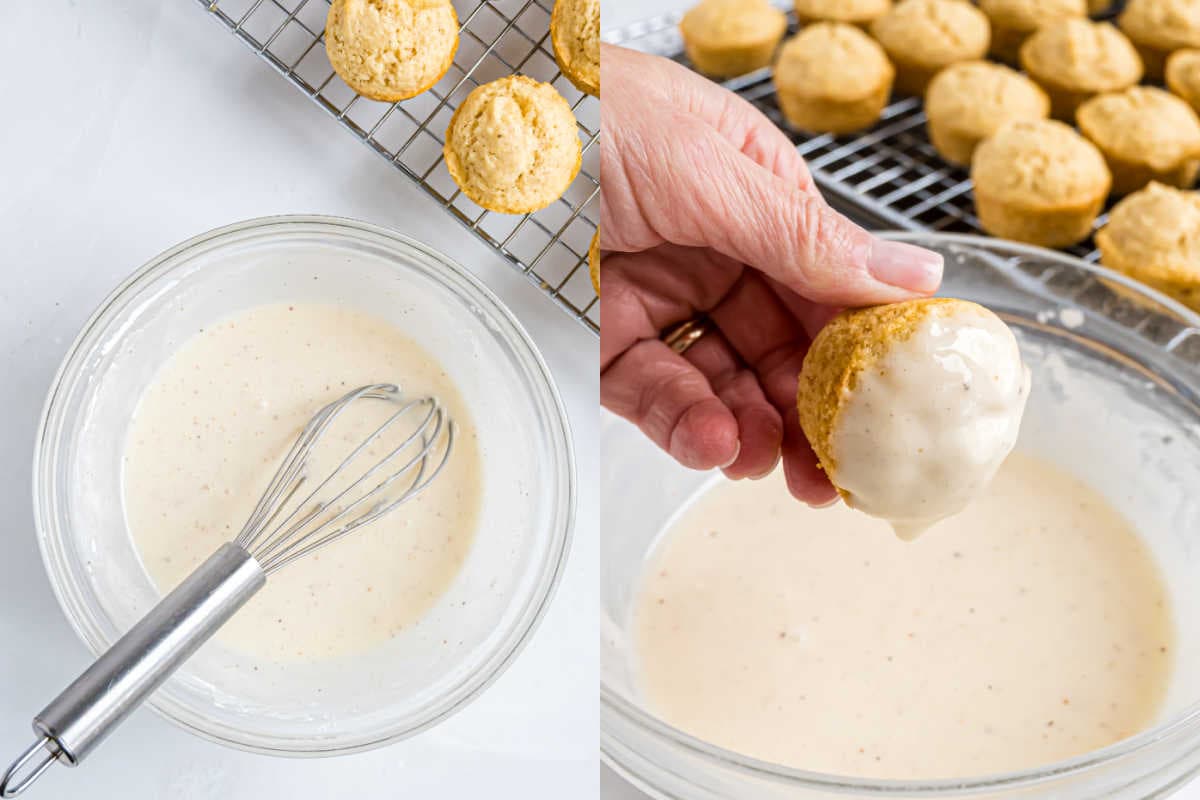 A bowl of glaze with a whisk and a hand dipping an eggnog muffin into the glaze, with more eggnog muffins on a cooling rack.
