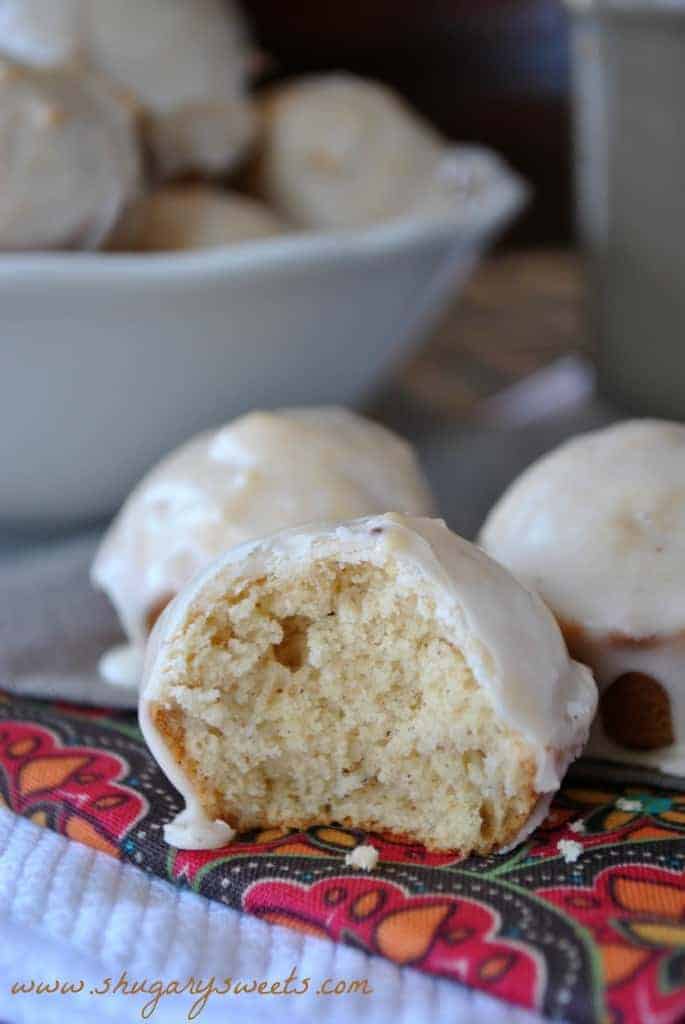 Close up of mini eggnog muffin with eggnog glaze and a bite removed.