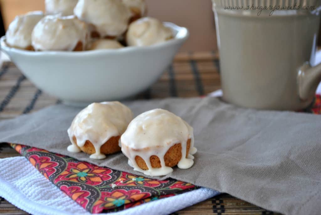 Two eggnog muffins with eggnog glaze on top.