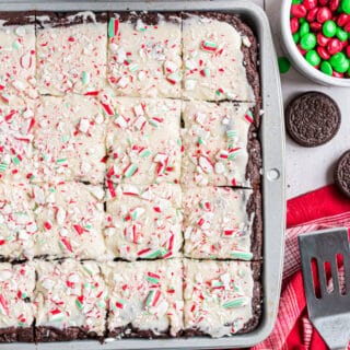 Rich chocolate Candy Cane Oreo Cookie Bars are topped with a white chocolate fudge and crushed peppermints. You can't beat the combo of chewy chocolate cookie bar and cool peppermint at Christmas time!