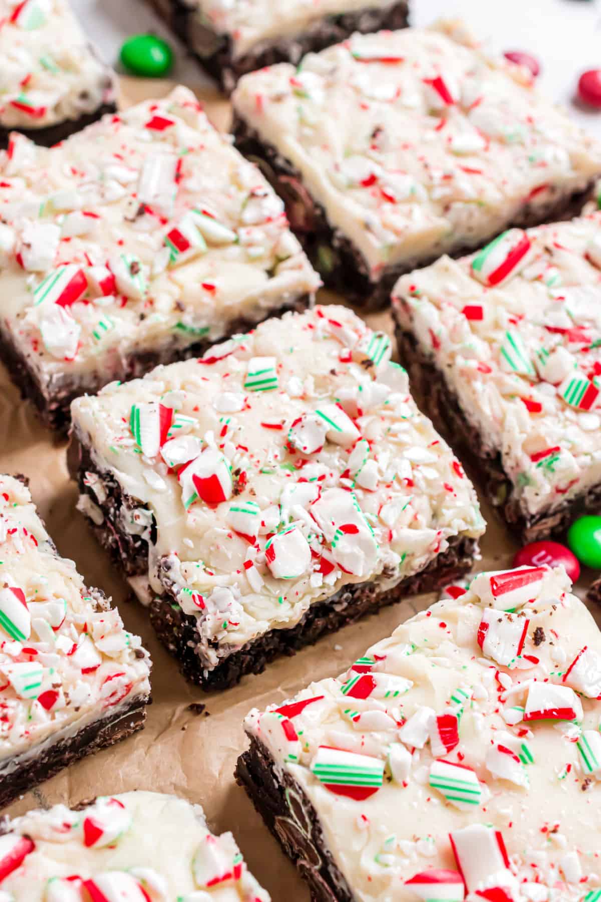 Chocolate cookie bars with white chocolate and candy canes cut into squares.