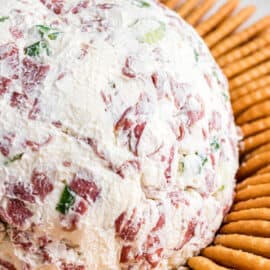 Chipped beef cheese ball served on a platter with buttery townhouse crackers.