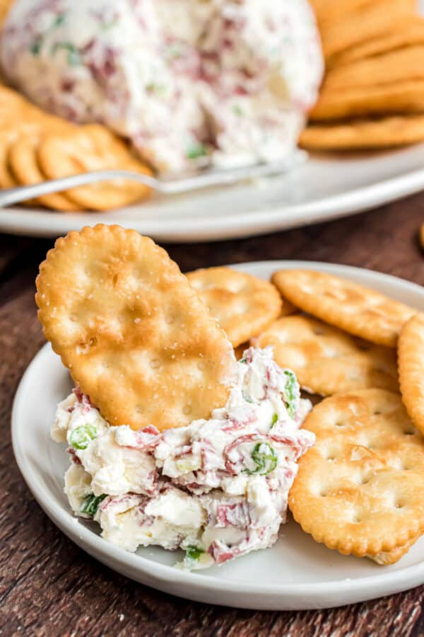 Buddig beef cheese ball served on a plate with crackers.