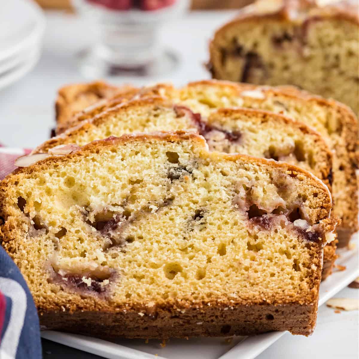 If you love homemade quick bread, this Cranberry Almond Bread recipe is a must try. Moist, delicious, and swirls of cranberries throughout. Bake up two freezer friendly loaves--one for now and one to enjoy later!