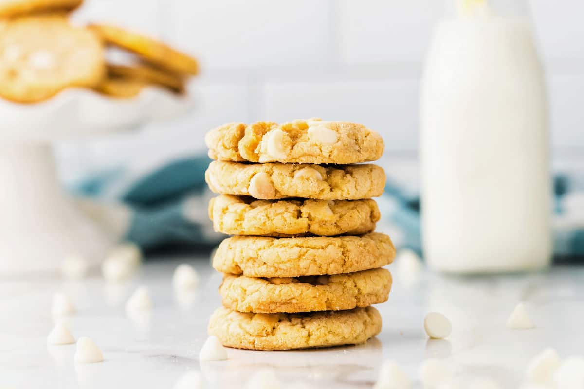 Lemon oreo cookies stacked on a counter.