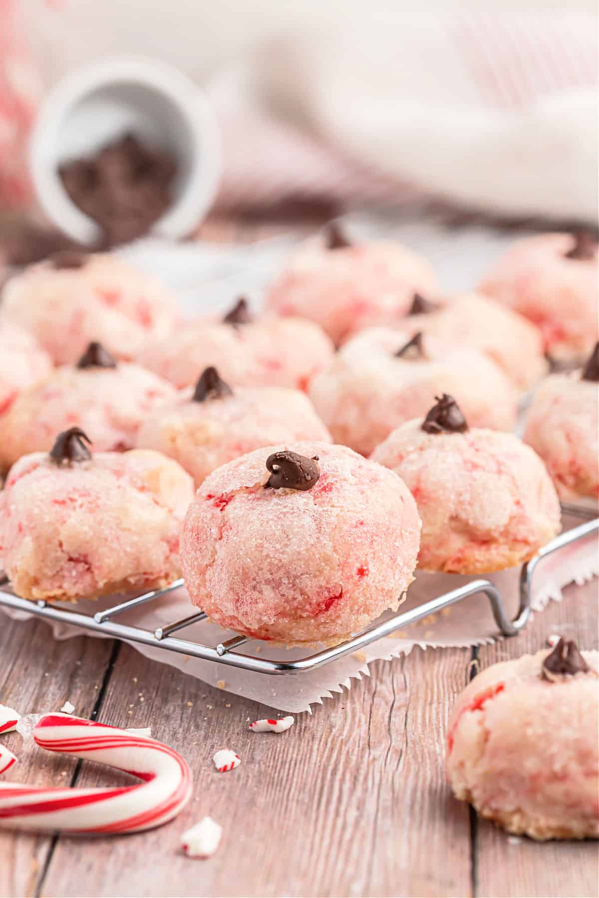 Peppermint cookies with a chocolate chip on a wire cooling rack.