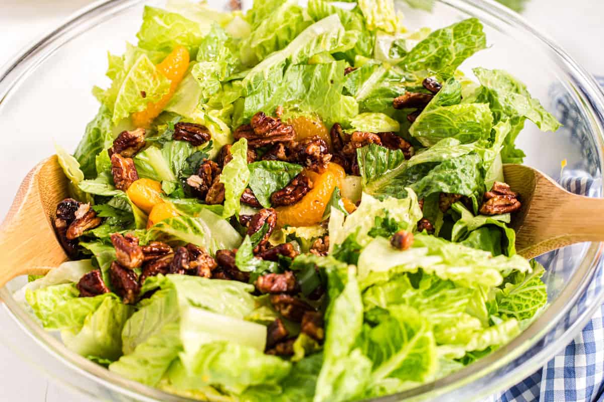 Mandarin salad with pecan on a clear glass bowl to serve.