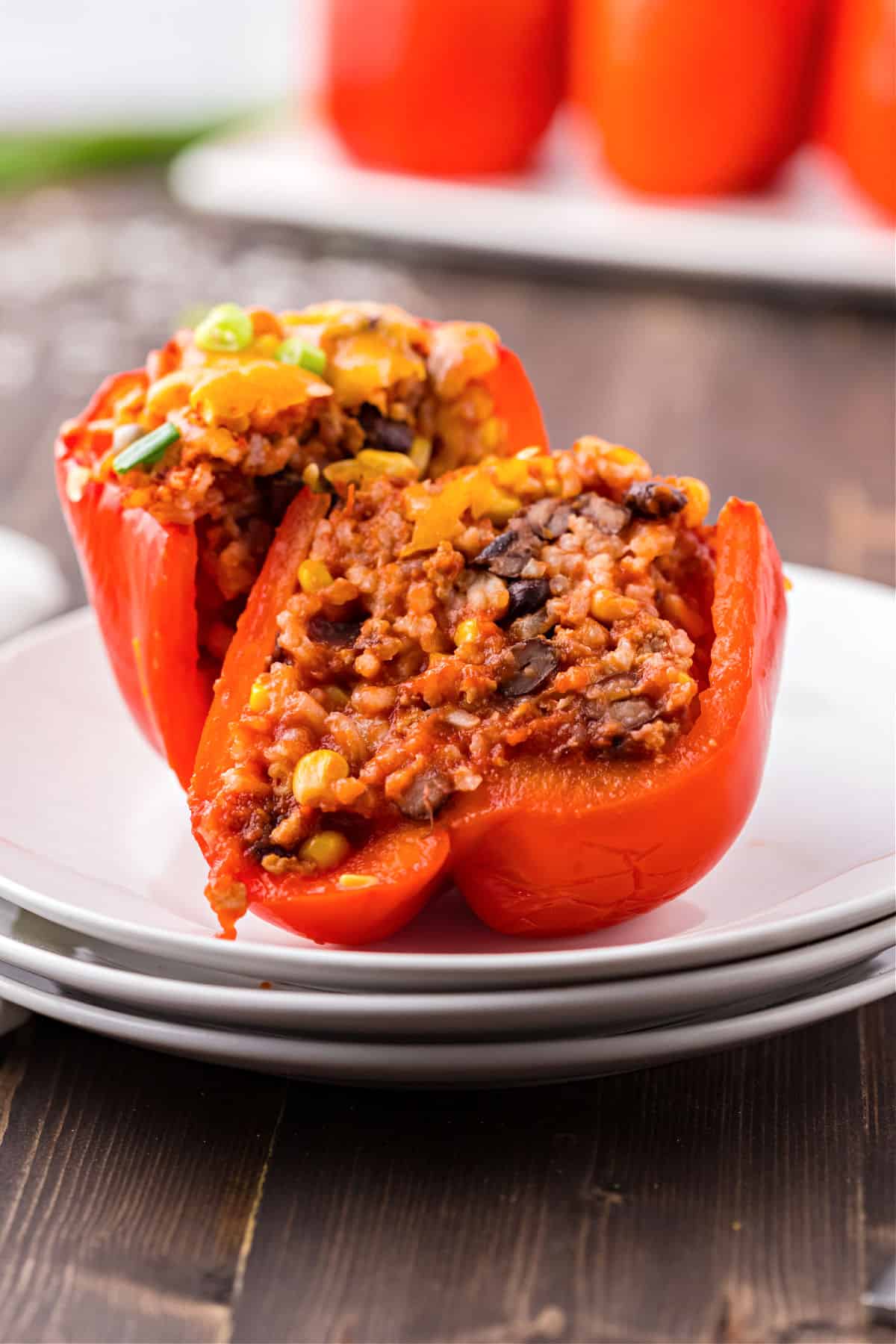 Stuffed red pepper cut in half on a plate.