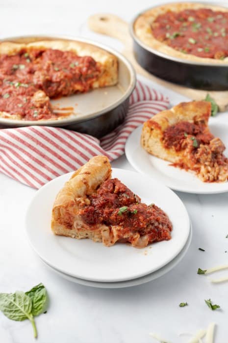 Slices of deep dish pizza on plates.