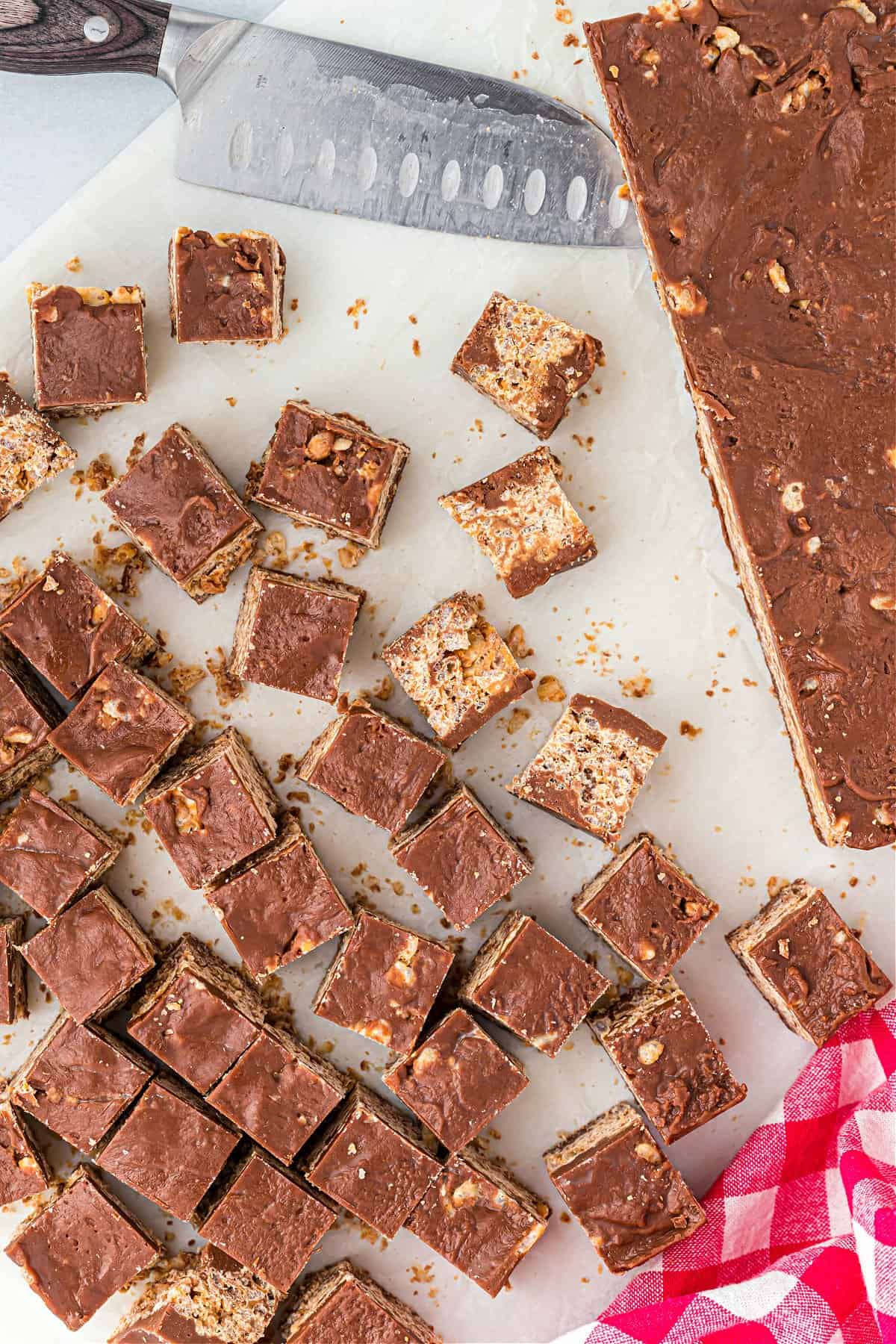 Kit Kat Bites cut into squares on a white cutting board.