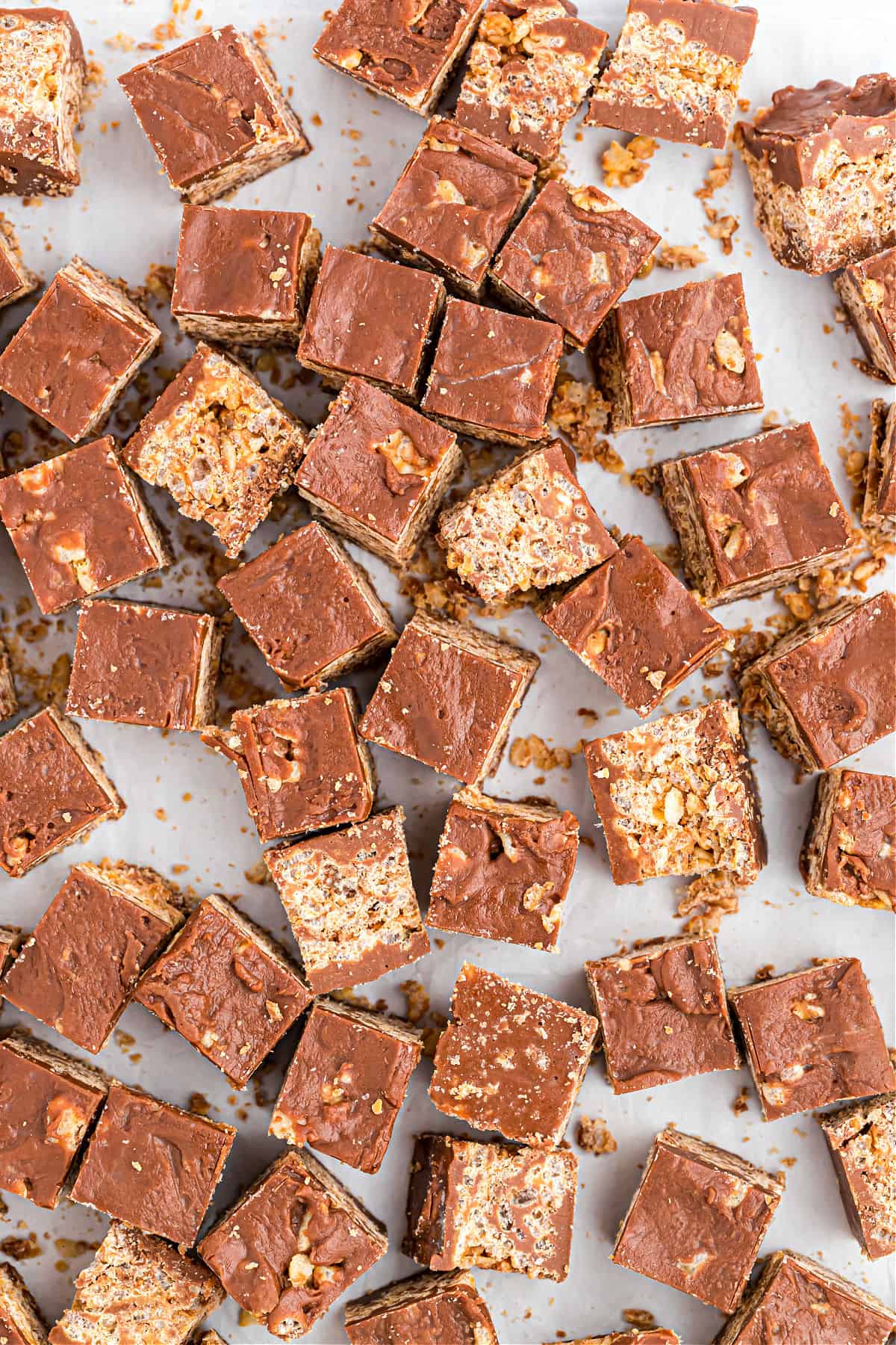 Kit kat bites spread on a parchment paper lined cookie sheet and cut into small squares.