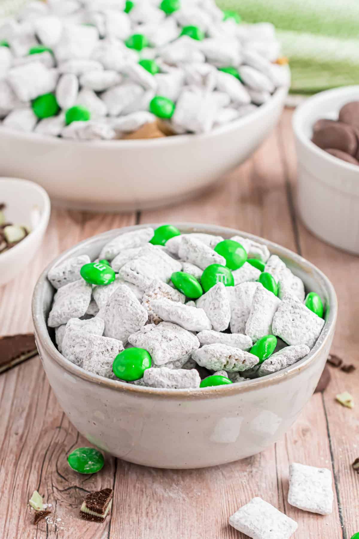 Mint puppy chow in a white serving bowl.