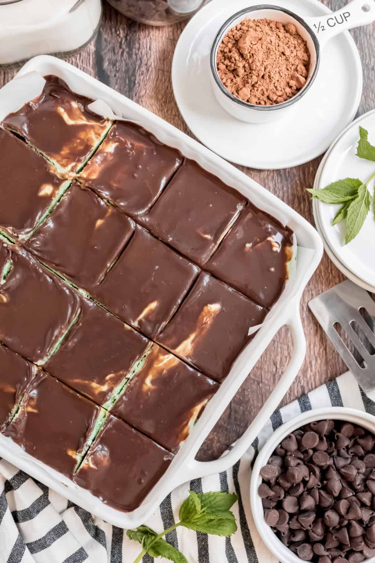 White baking dish with chocolate mint brownies sliced and ready to serve.