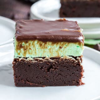 Slice of chocolate brownies with mint filling and chocolate ganache.