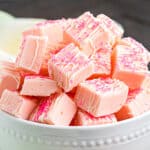 Small pieces of pink fudge in a white bowl.