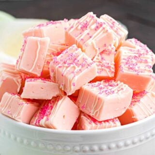 Small pieces of pink fudge in a white bowl.