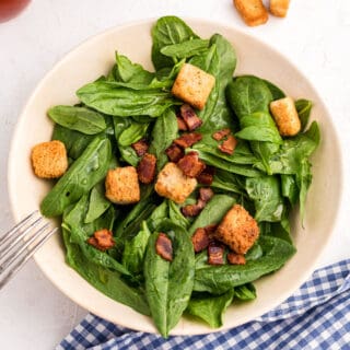 This delicious Spinach and Bacon Salad is a breeze to prepare! The sweet dressing with the salty bacon keeps you wanting more. Served for lunch or as a light dinner, it's the best way to get your daily greens.