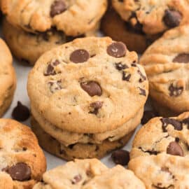 Peanut butter chocolate chip cookies stacked on top of eachother.