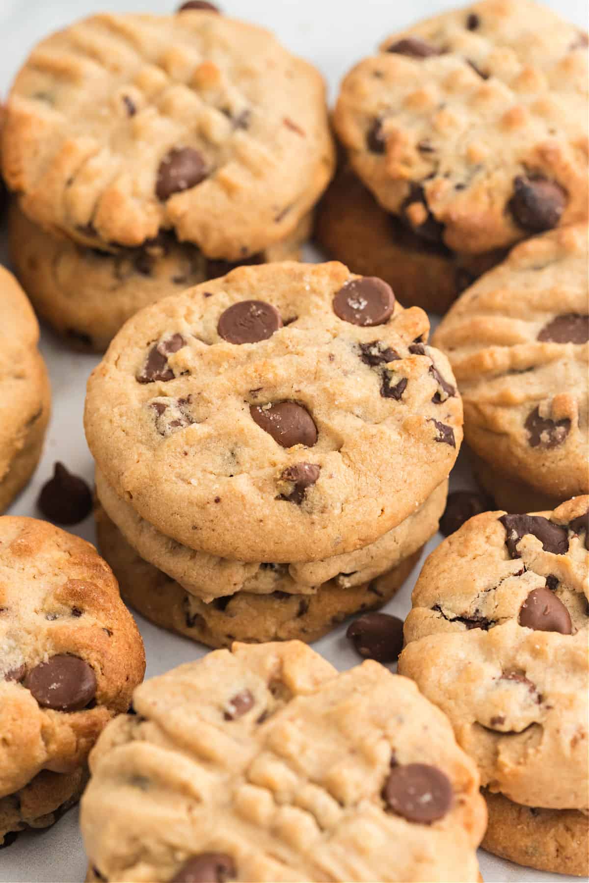 Peanut butter chocolate chip cookies stacked on top of eachother.