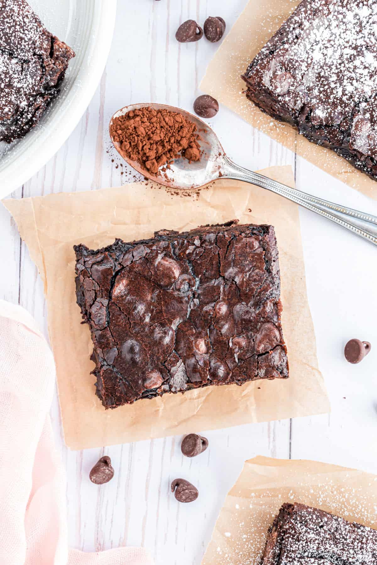 Slice of brownie on parchment paper.