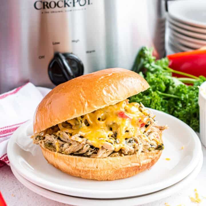 Dinner time is better when these Slow Cooker Italian Chicken Sandwiches are on the menu! Cheesy sandwiches are filled with Italian seasoned chicken and red peppers in this easy recipe.