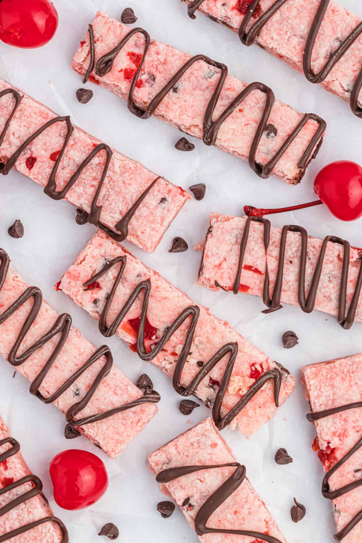 Shortbread cookies with cherries and chocolate drizzle.