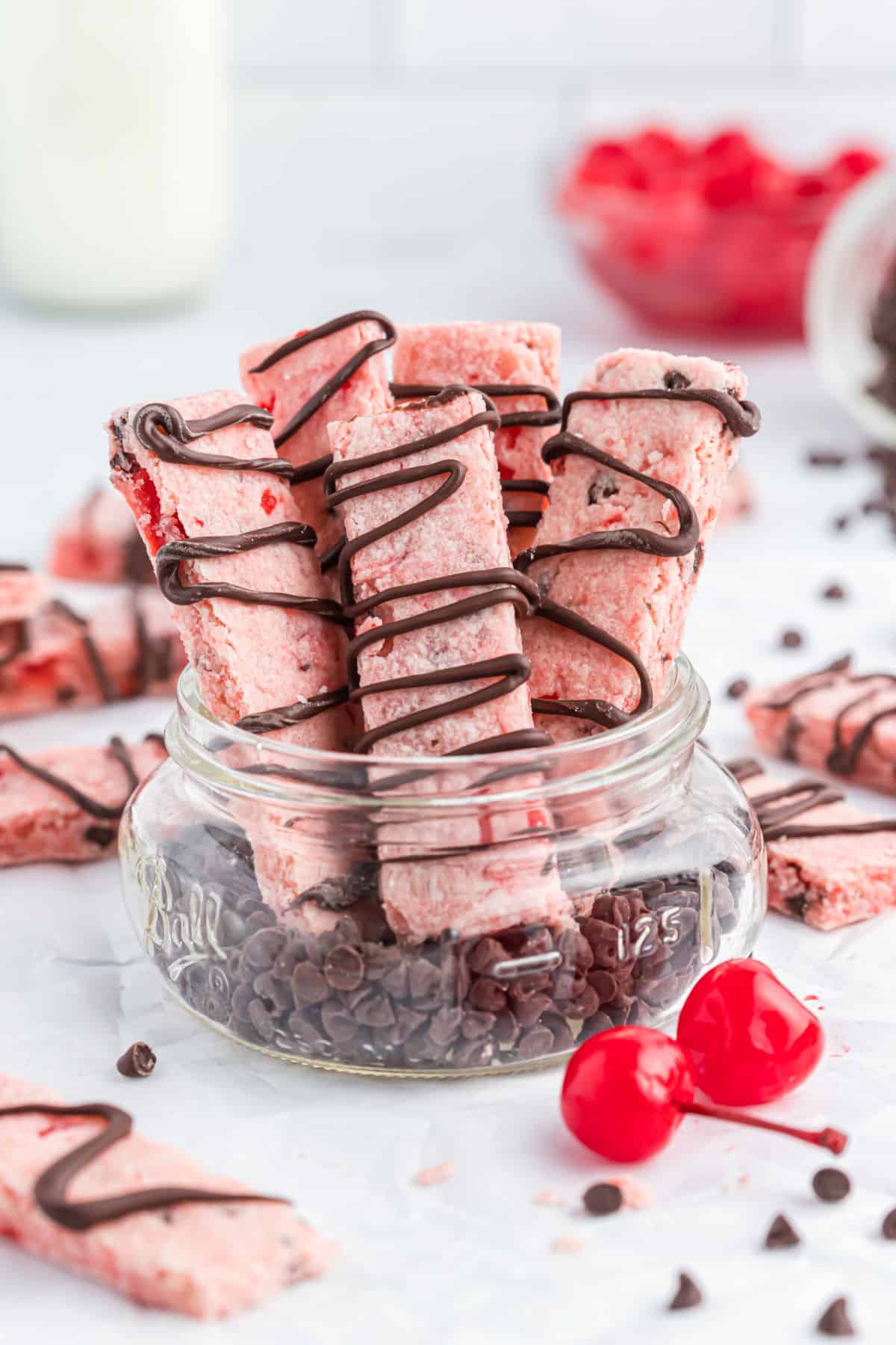 Cherry shortbread cookies in a small jar.