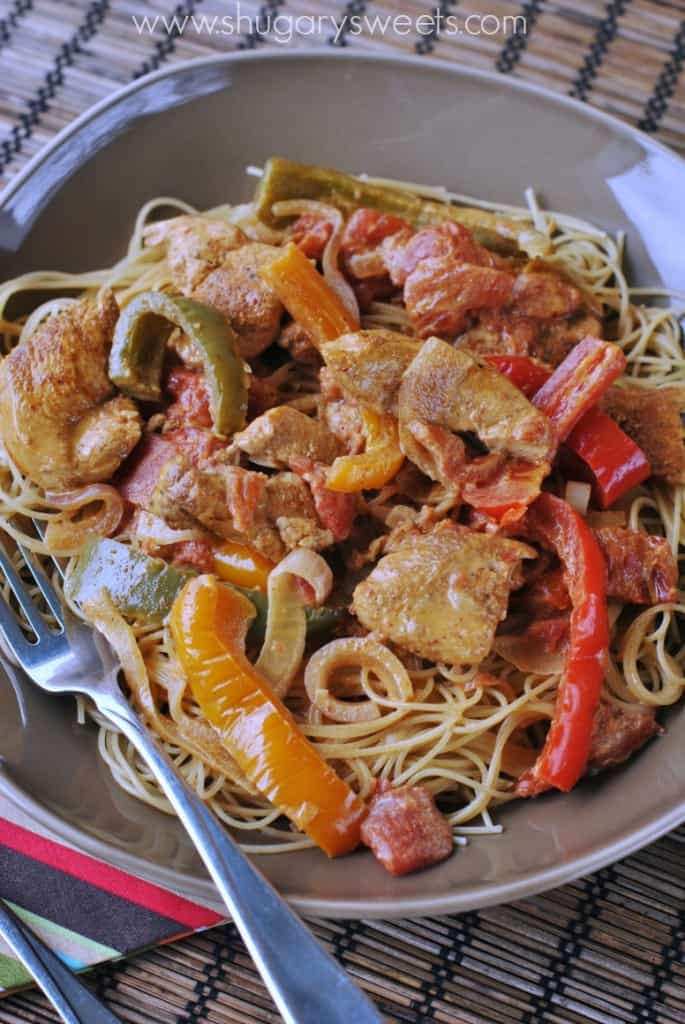 Serving size bowl of angel hair pasta with cajun sauce and chicken.