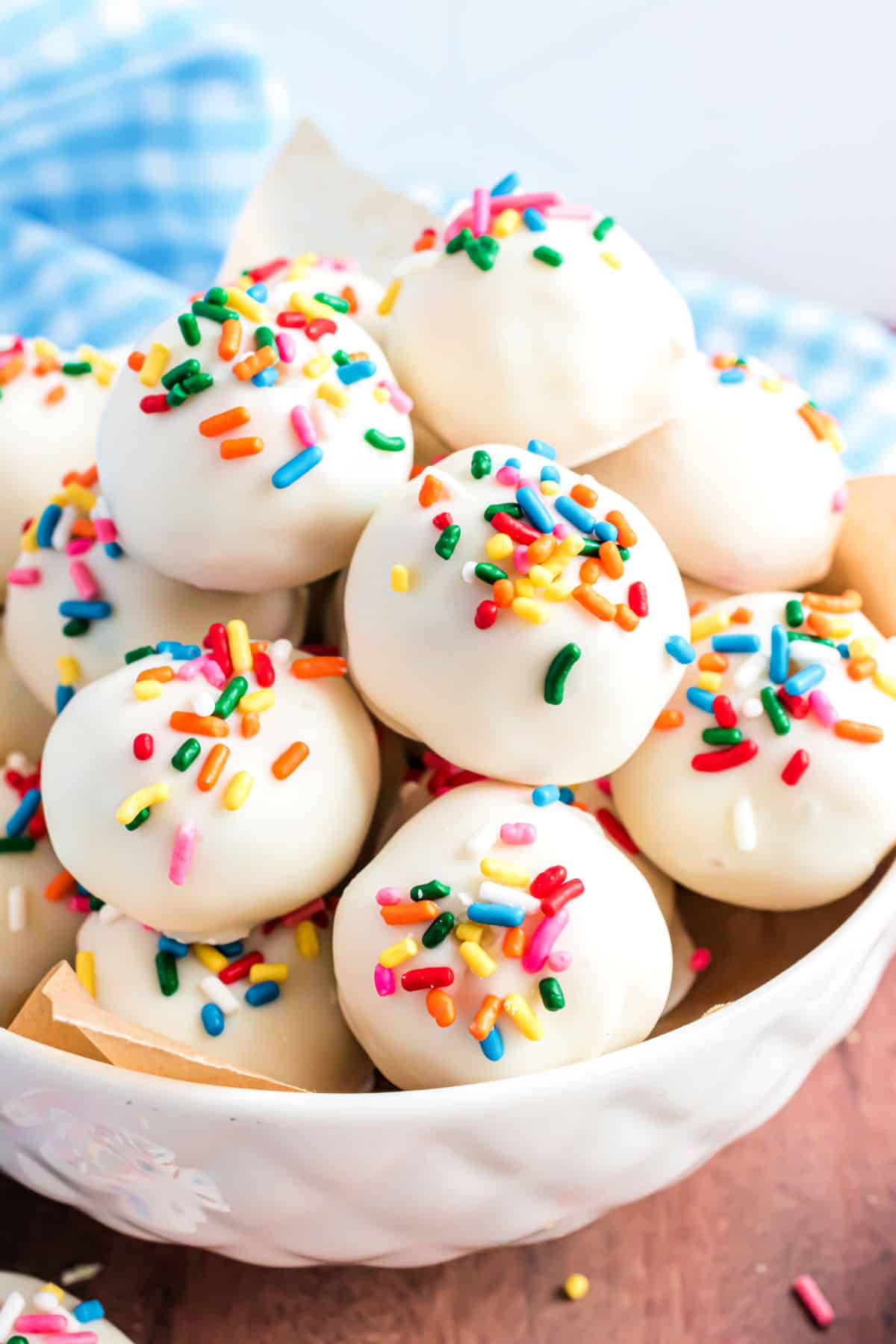 Sprinkles truffles in a white serving bowl.