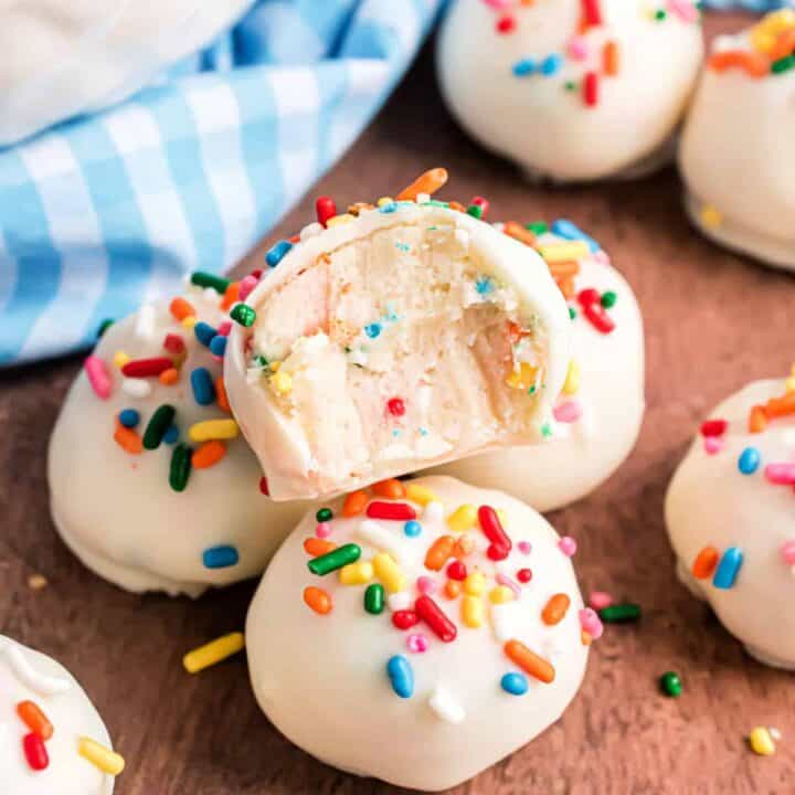Funfetti cookie dough is rolled into tasty truffles in this easy dessert recipe. Dipped in white chocolate and covered in sprinkles, these Funfetti Truffles are a hit for birthday and graduation parties!