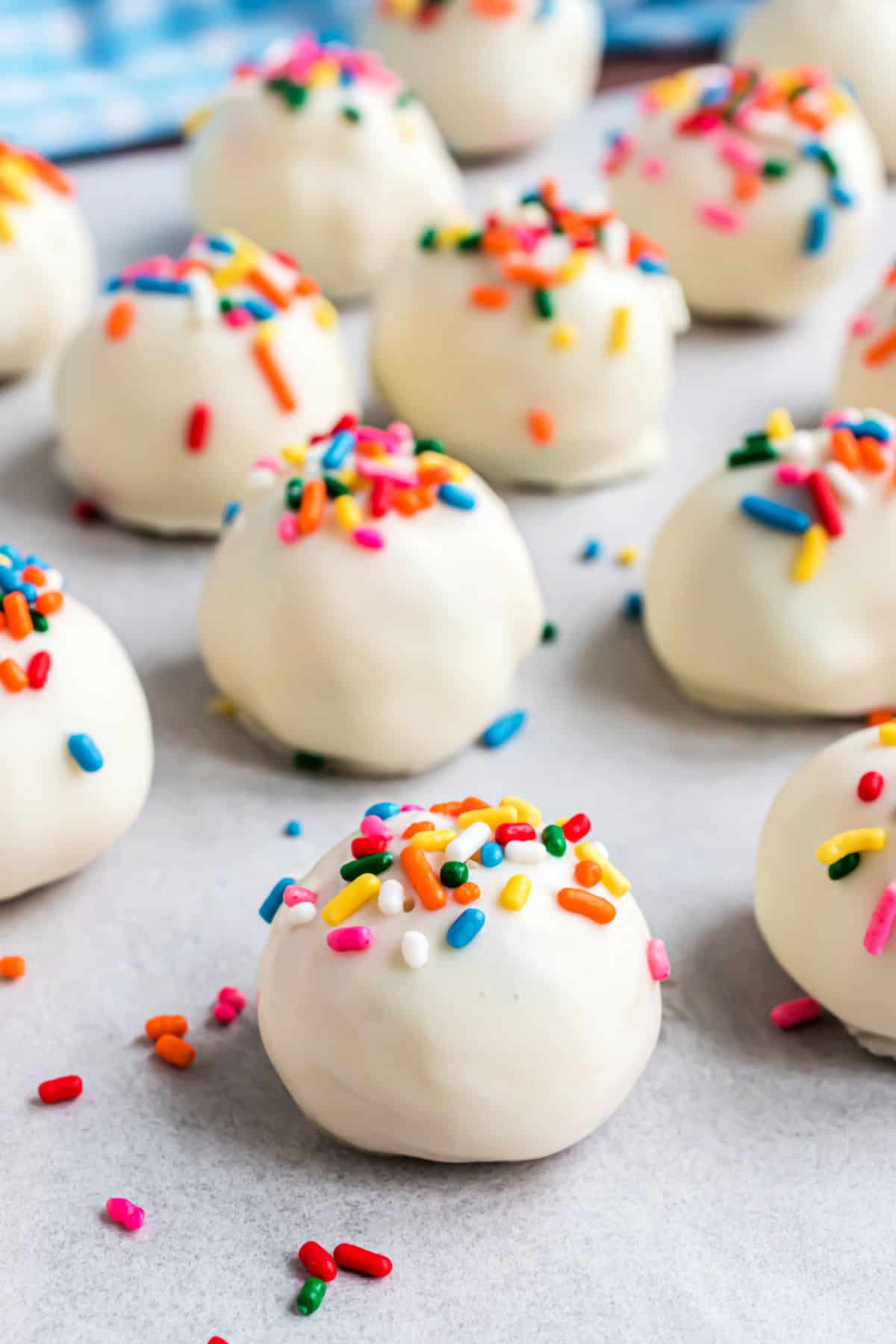 Funfetti truffles with white chocolate and sprinkles on parchment paper.