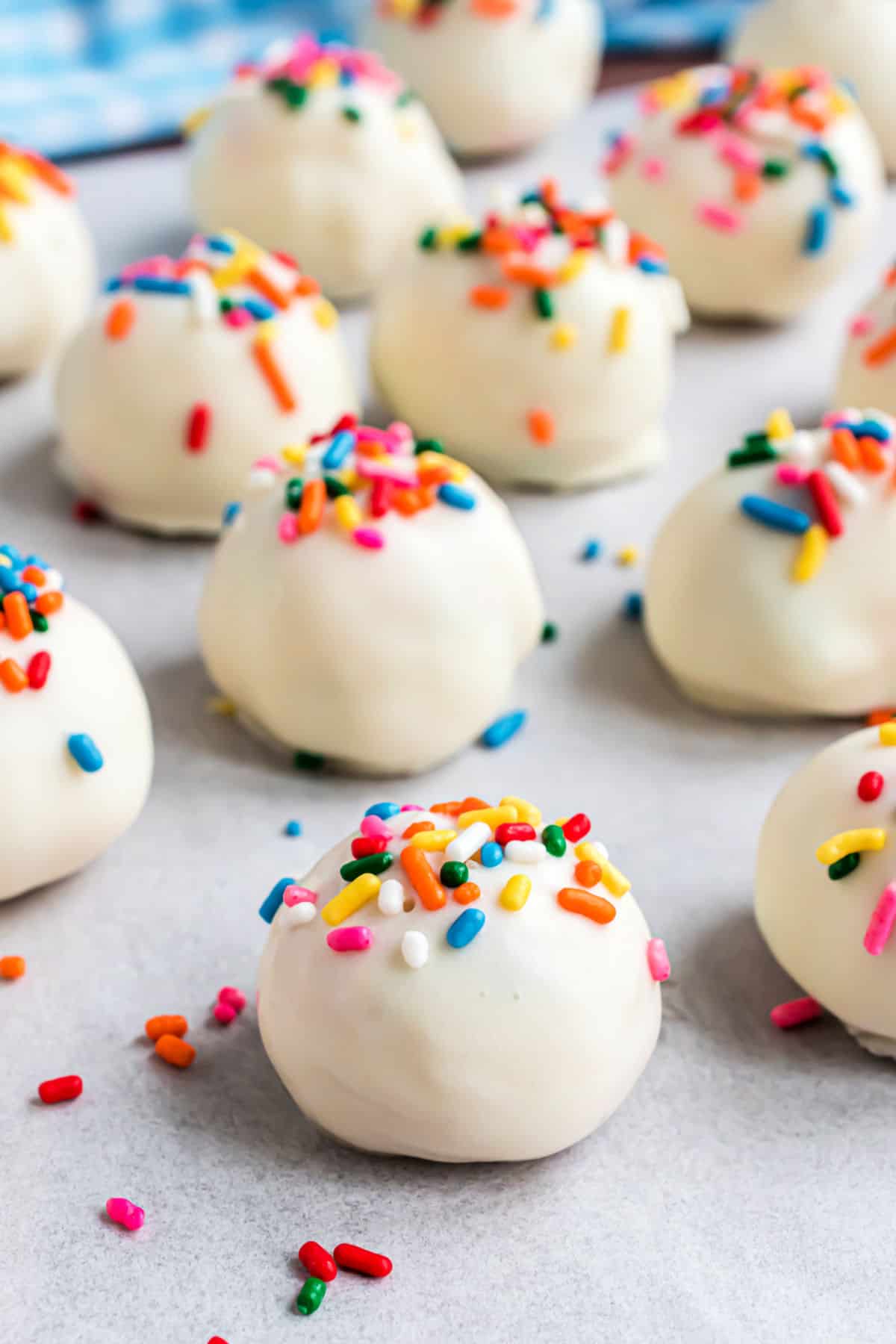 Funfetti truffles with white chocolate and sprinkles on parchment paper.